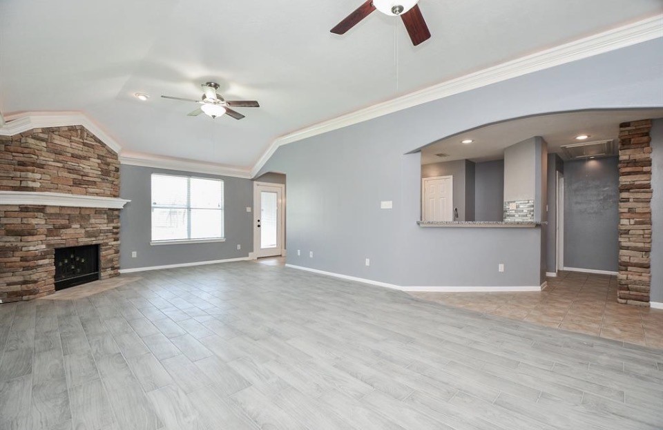 8515 Split Branch Lane Houston, TX 77095 - Photo 5 of 31 an empty room with windows and fireplace