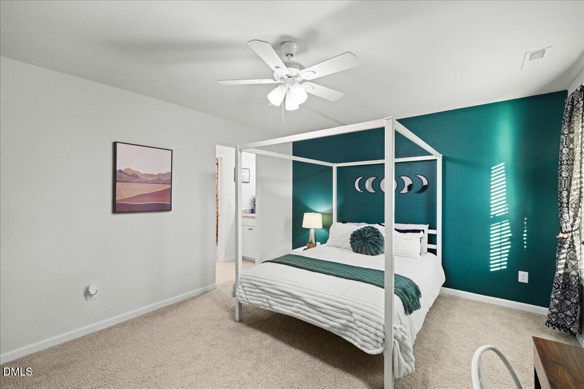 7804 Charters End Street Willow Spring, NC 27592 - Photo 31 of 43 a bedroom with a bed and ceiling fan
