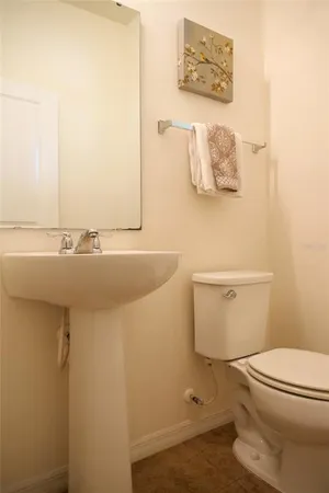 a bathroom with a sink a toilet and mirror