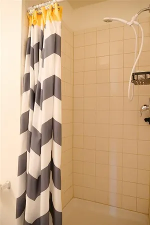 a bathroom with a shower and a mirror