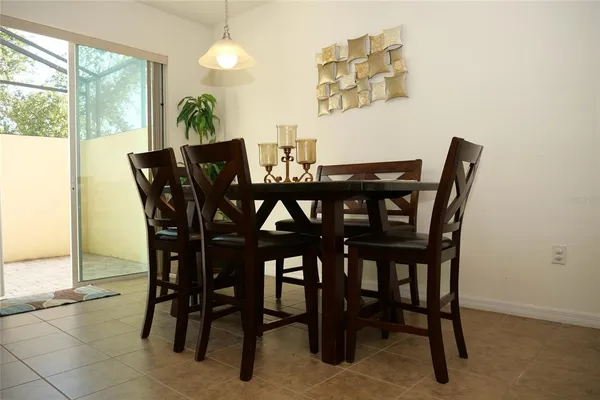 a view of a dining room with furniture and a floor to ceiling window
