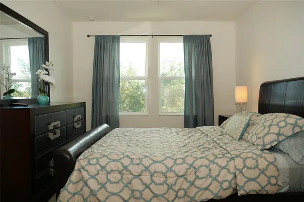 a bedroom with a bed and a window