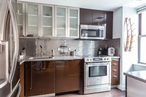 a kitchen with stainless steel appliances granite countertop a stove and a microwave