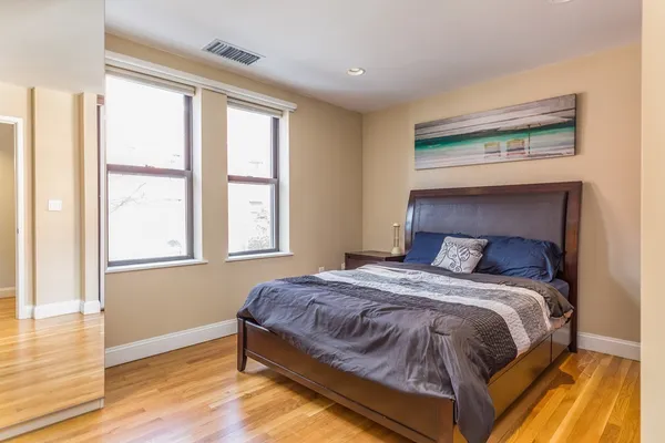 a bedroom with a bed and window