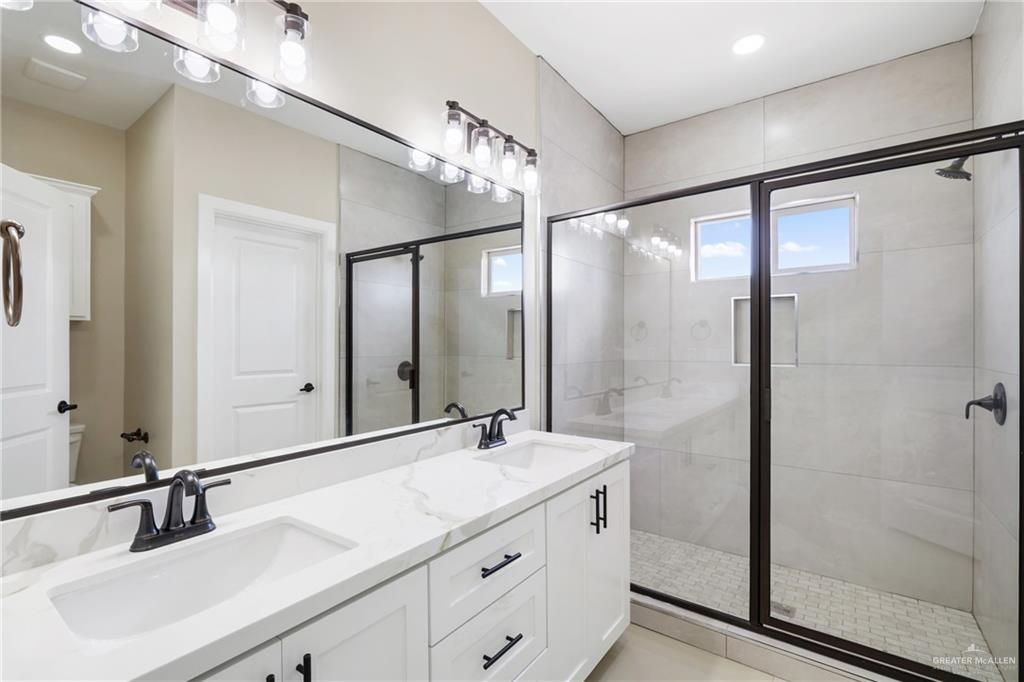 105 Lenon Street Edcouch, TX 78538 - Photo 11 of 19 a bathroom with a double vanity sink and mirror