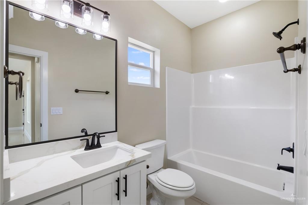 105 Lenon Street Edcouch, TX 78538 - Photo 14 of 19 a bathroom with a sink a toilet and shower