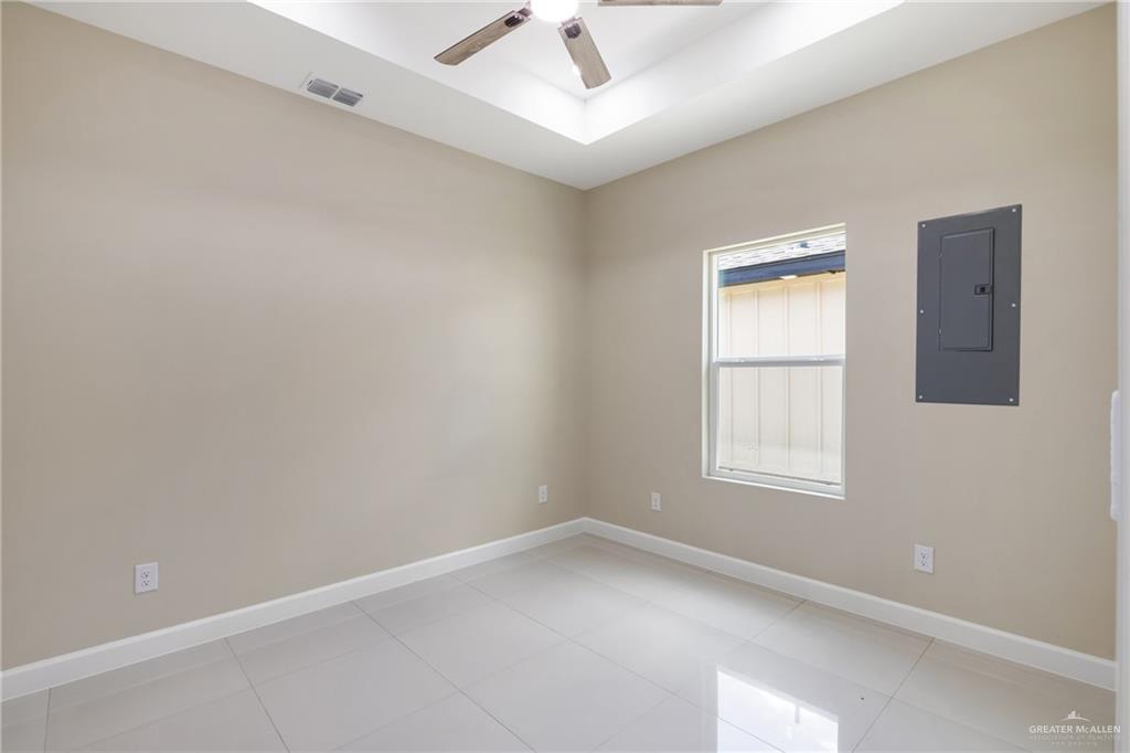 105 Lenon Street Edcouch, TX 78538 - Photo 16 of 19 an empty room with a window and a ceiling fan