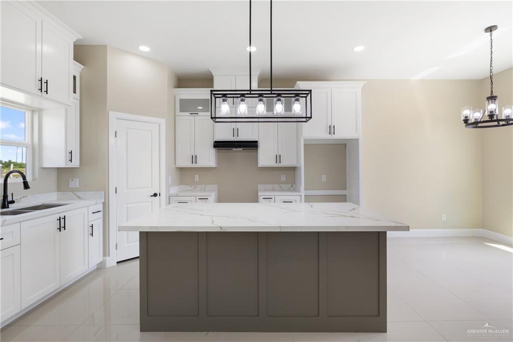 105 Lenon Street Edcouch, TX 78538 - Photo 3 of 19 a kitchen with kitchen island granite countertop a sink stainless steel appliances and cabinets