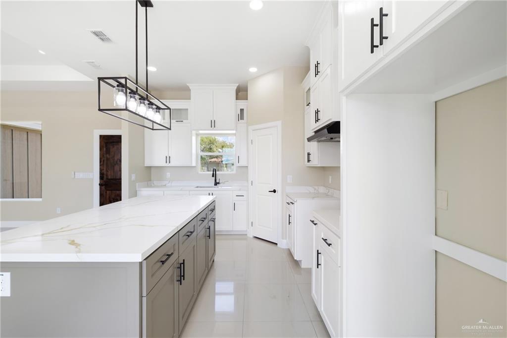 105 Lenon Street Edcouch, TX 78538 - Photo 5 of 19 a kitchen with stainless steel appliances kitchen island a refrigerator and a sink