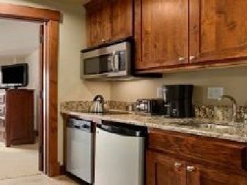 1979 Ski Hill Road, Unit 1314AB Breckenridge, CO 80424 - Photo 11 of 14 a kitchen with stainless steel appliances granite countertop a stove a sink and a microwave