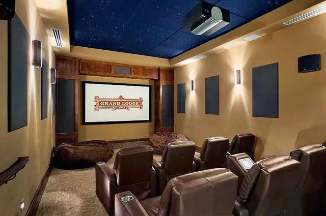 a projector room with furniture and a projector screen
