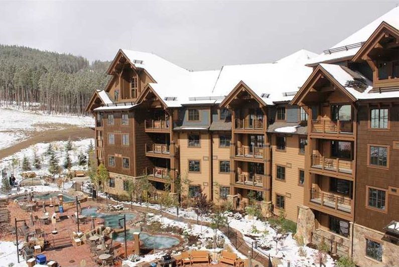 1979 Ski Hill Road, Unit 1314AB Breckenridge, CO 80424 - Photo 2 of 14 a front view of a residential apartment building with a yard