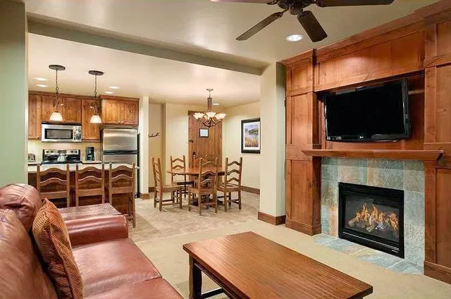 a living room with furniture a flat screen tv and a fireplace