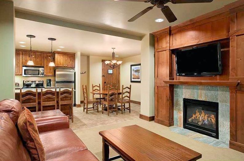 1979 Ski Hill Road, Unit 1314AB Breckenridge, CO 80424 - Photo 4 of 14 a living room with furniture a flat screen tv and a fireplace