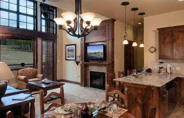 a living room with fireplace furniture and a chandelier