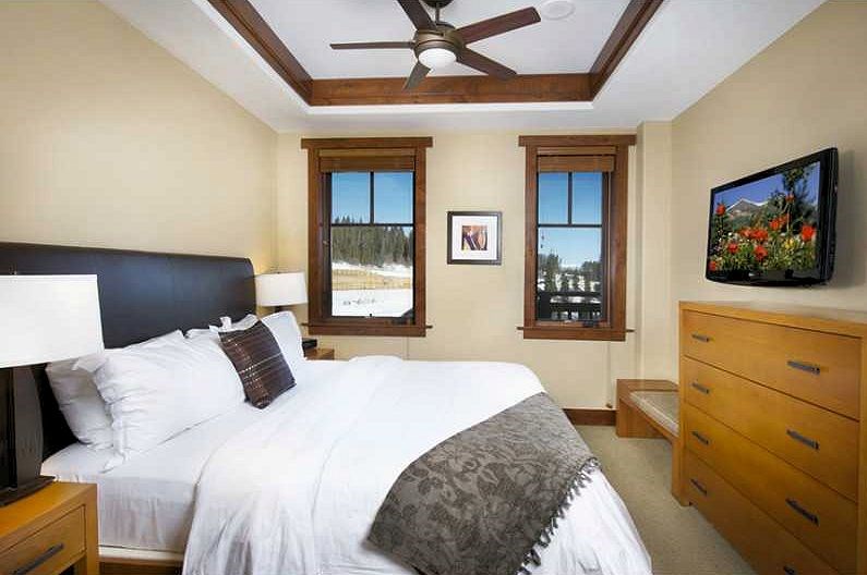 1979 Ski Hill Road, Unit 1314AB Breckenridge, CO 80424 - Photo 6 of 14 a bedroom with a bed and a flat screen tv