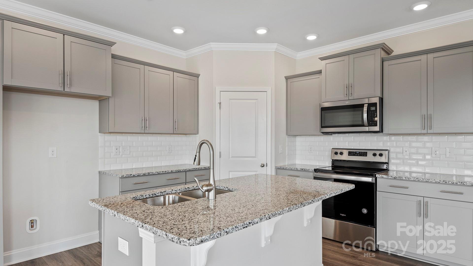 313 Lagoon Road Fletcher, NC 28732 - Photo 5 of 34 a kitchen with stainless steel appliances granite countertop a sink stove and cabinets