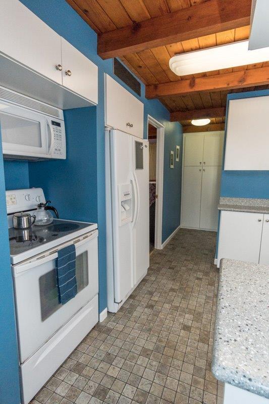 45852 Mineral King Road Three Rivers, CA 93271 - Photo 9 of 36 a kitchen with a stove and a refrigerator