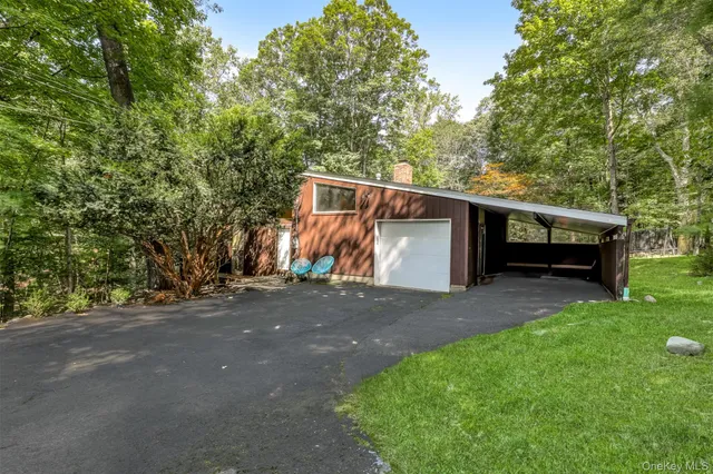 a view of backyard with a car parked in the road