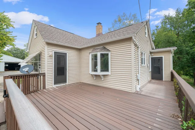 a view of a house with wooden deck