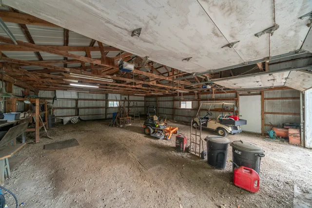 an aerial view of residential houses with outdoor space and lake view