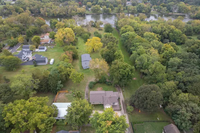 an aerial view of a house with a yard