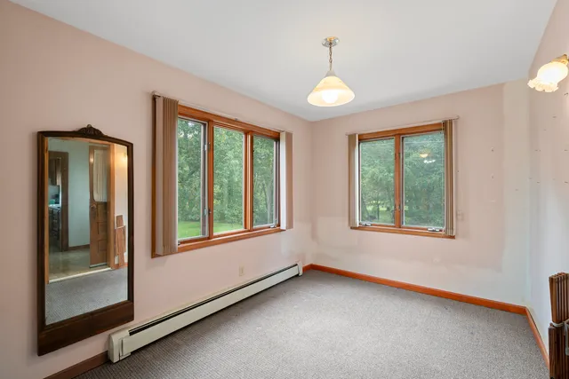 a view of a room that has a bed and a window