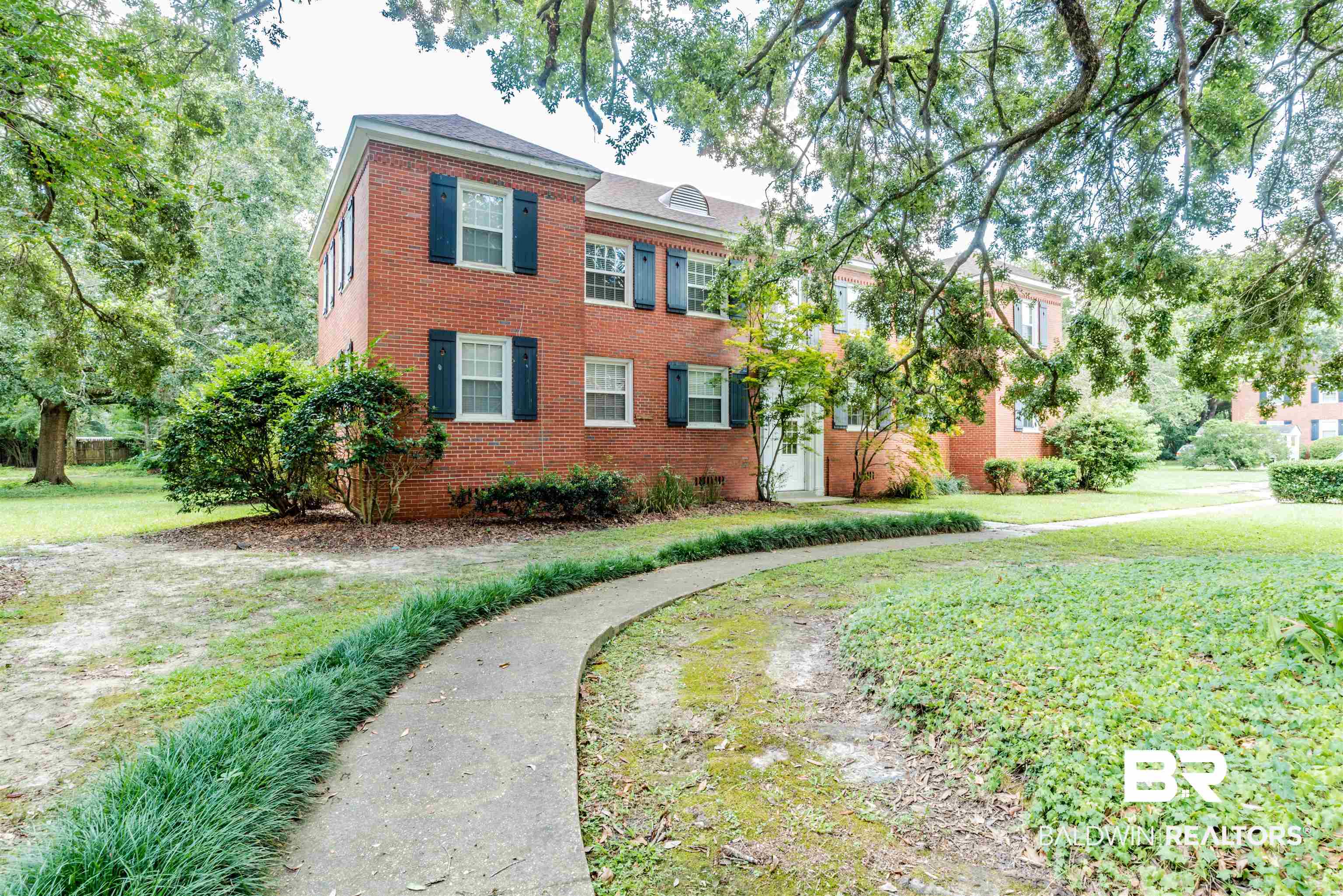 214 Upham Street, Unit 7C Mobile, AL 36607 - Photo 20 of 32 Colonial inspired home featuring a front lawn and brick siding