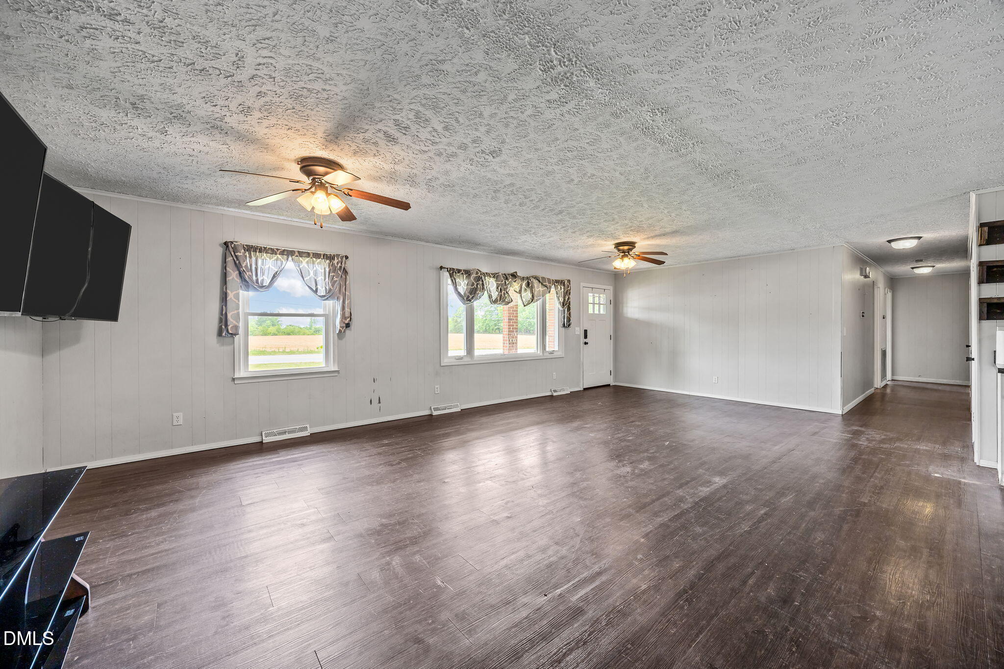 786 Dick Holeman Road Timberlake, NC 27583 - Photo 16 of 44 a view of an empty room with a window and wooden floor