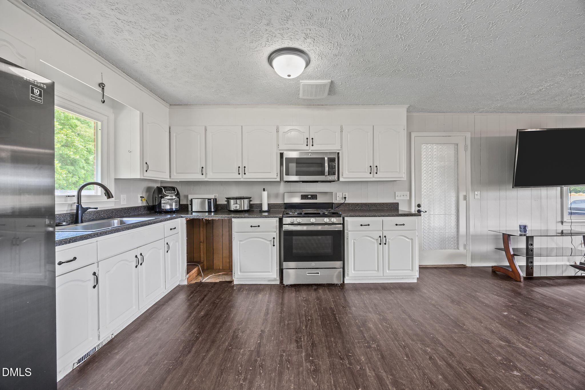 786 Dick Holeman Road Timberlake, NC 27583 - Photo 18 of 44 a kitchen with granite countertop a sink cabinets and wooden floor