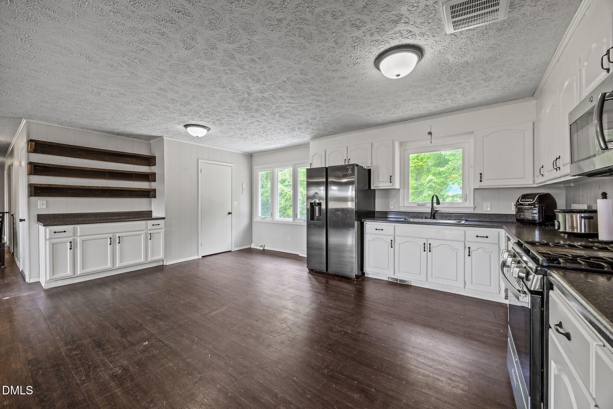 786 Dick Holeman Road Timberlake, NC 27583 - Photo 20 of 44 a kitchen with stainless steel appliances a refrigerator stove and sink