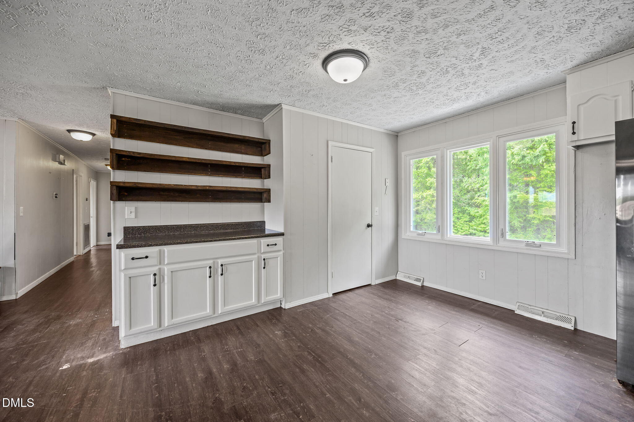 786 Dick Holeman Road Timberlake, NC 27583 - Photo 21 of 44 an empty room with wooden floor cabinet and windows