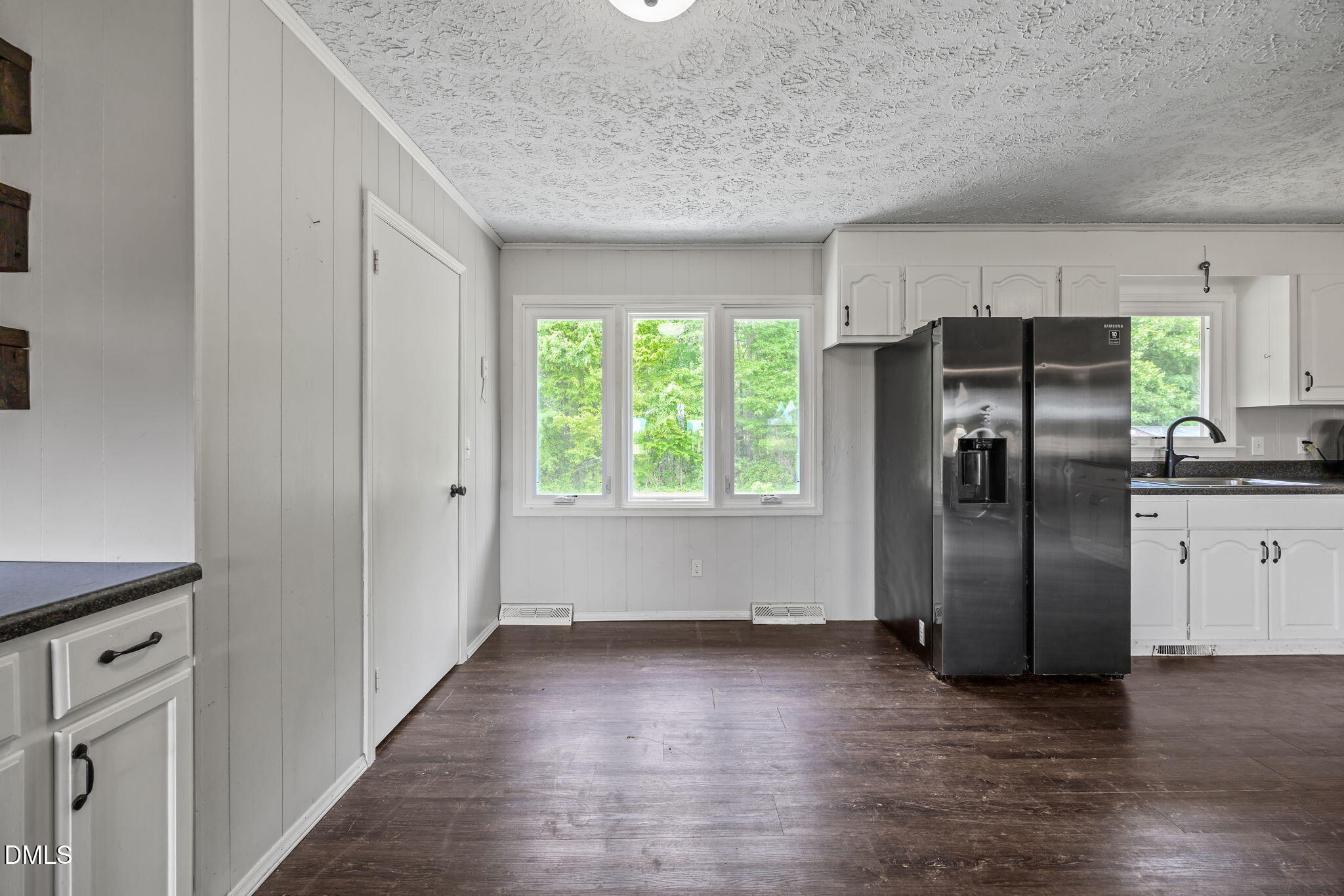 786 Dick Holeman Road Timberlake, NC 27583 - Photo 22 of 44 a view of a kitchen with a refrigerator cabinets and a wooden floor