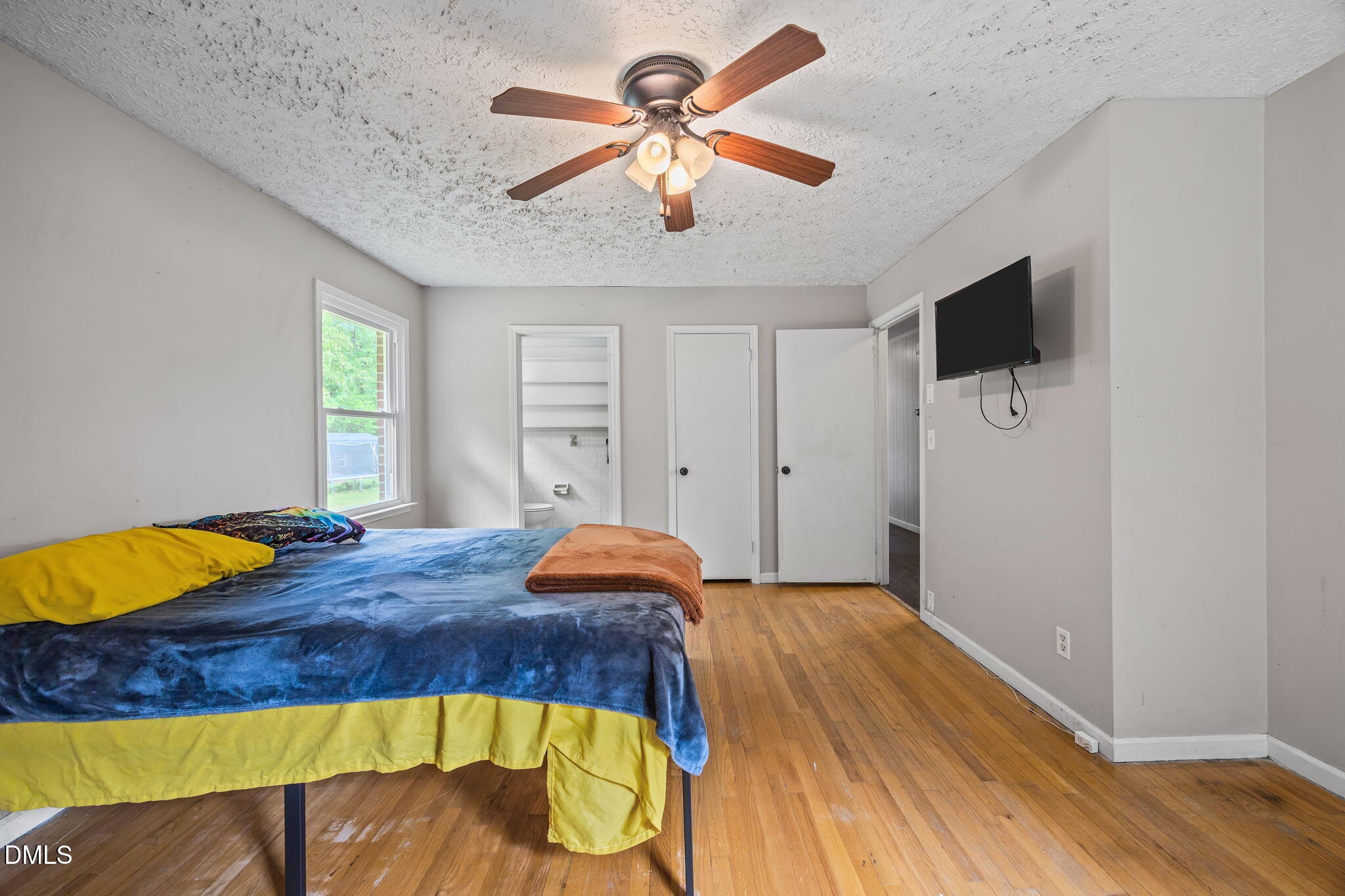 786 Dick Holeman Road Timberlake, NC 27583 - Photo 25 of 44 a bedroom with a bed and a chandelier