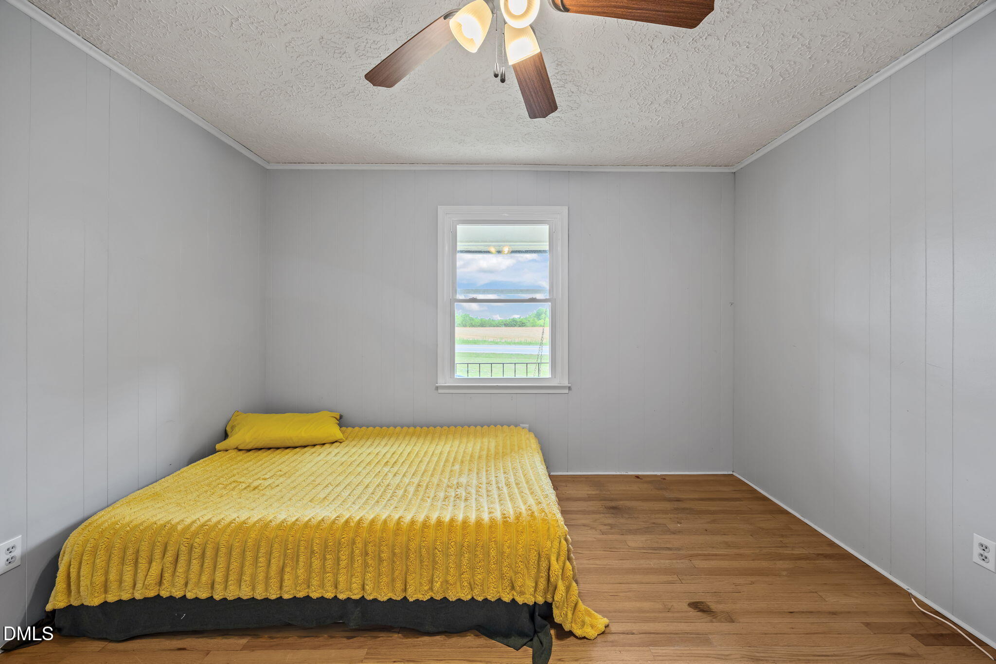 786 Dick Holeman Road Timberlake, NC 27583 - Photo 28 of 44 a bedroom with a bed and wooden floor