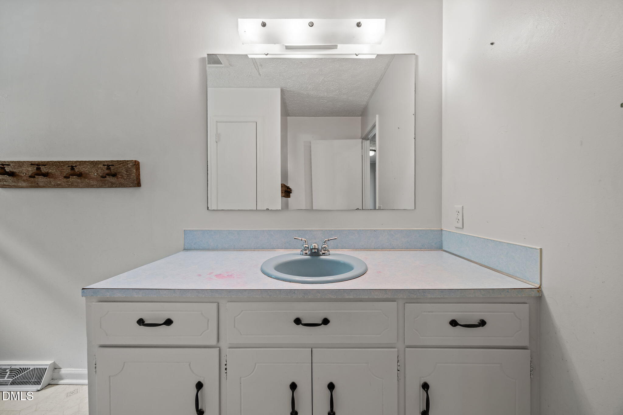 786 Dick Holeman Road Timberlake, NC 27583 - Photo 30 of 44 a bathroom with a sink and a mirror