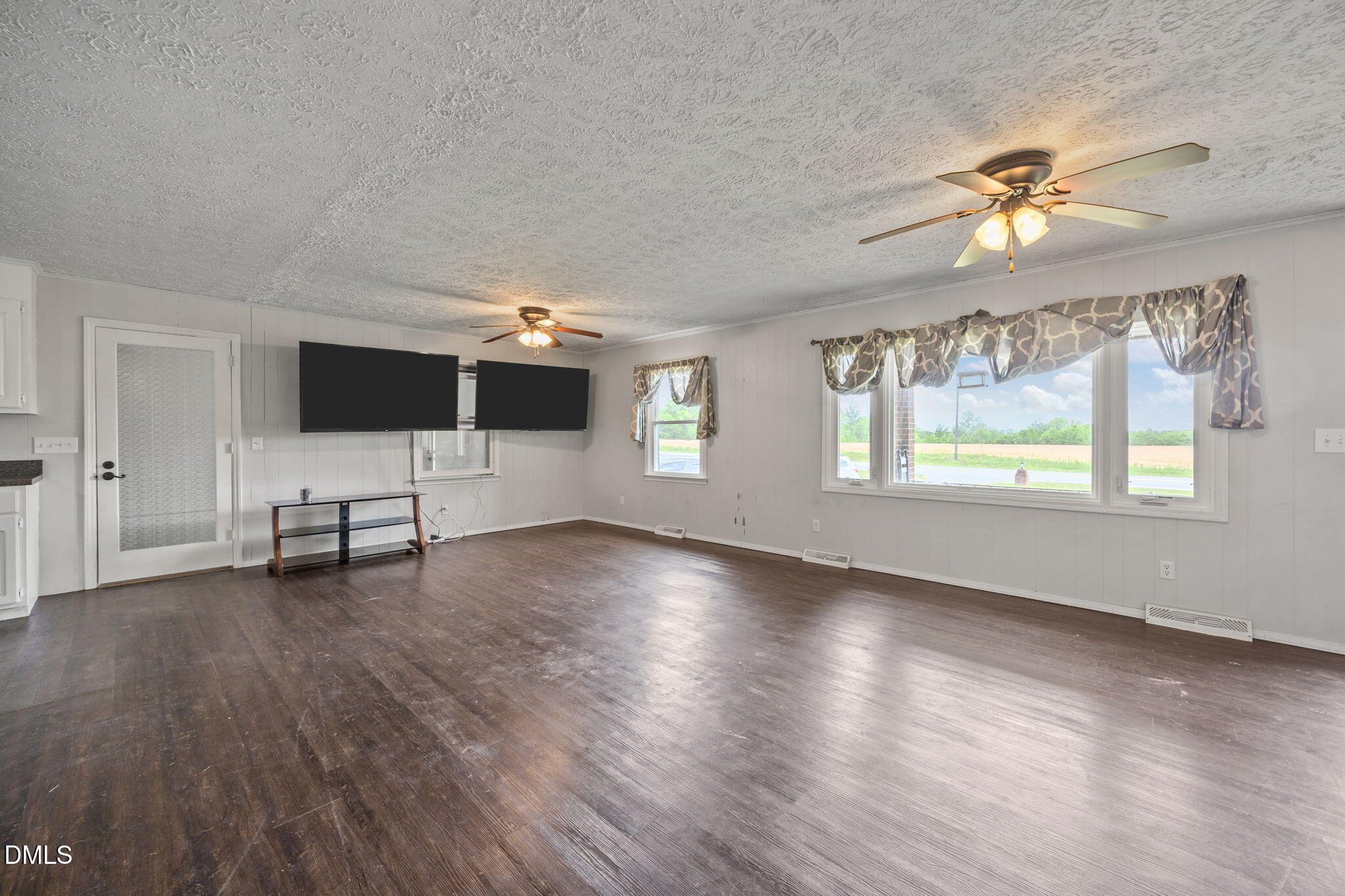786 Dick Holeman Road Timberlake, NC 27583 - Photo 4 of 44 a view of a livingroom with a flat screen tv and a window