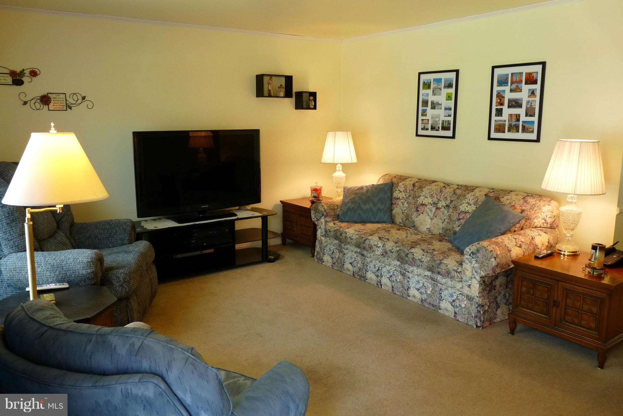 1812 Willann Road Baltimore, MD 21237 - Photo 2 of 26 a living room with furniture and a flat screen tv
