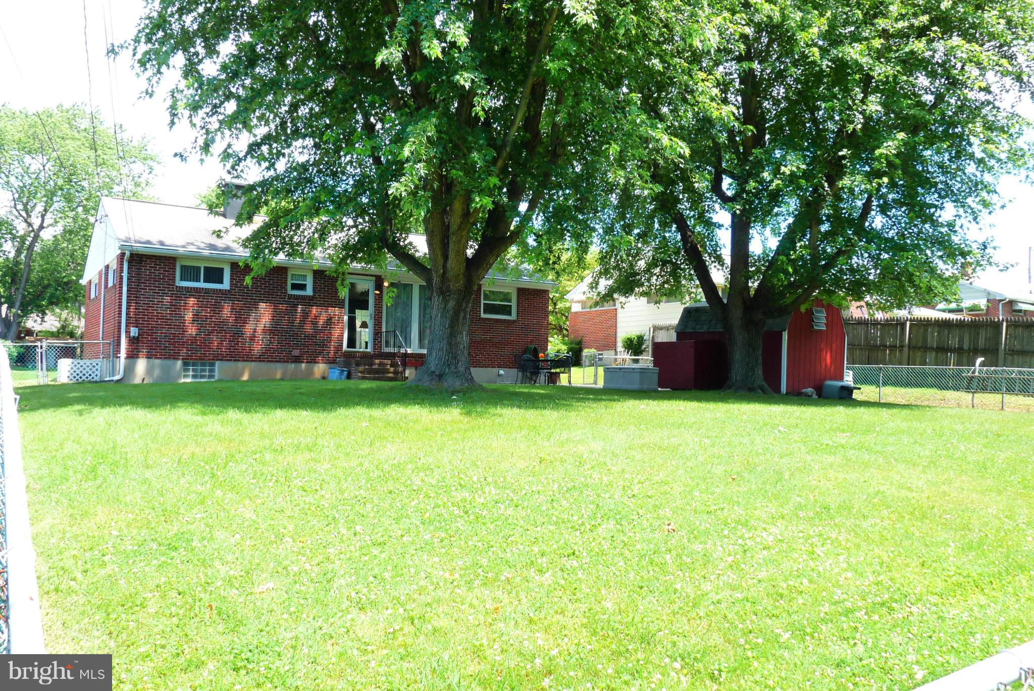1812 Willann Road Baltimore, MD 21237 - Photo 23 of 26 a view of a house with backyard and a tree