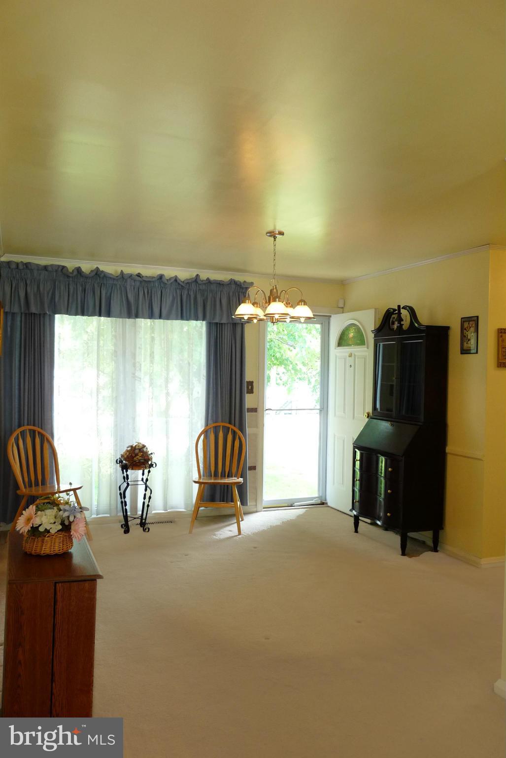 1812 Willann Road Baltimore, MD 21237 - Photo 4 of 26 a living room with furniture a fireplace and a large window