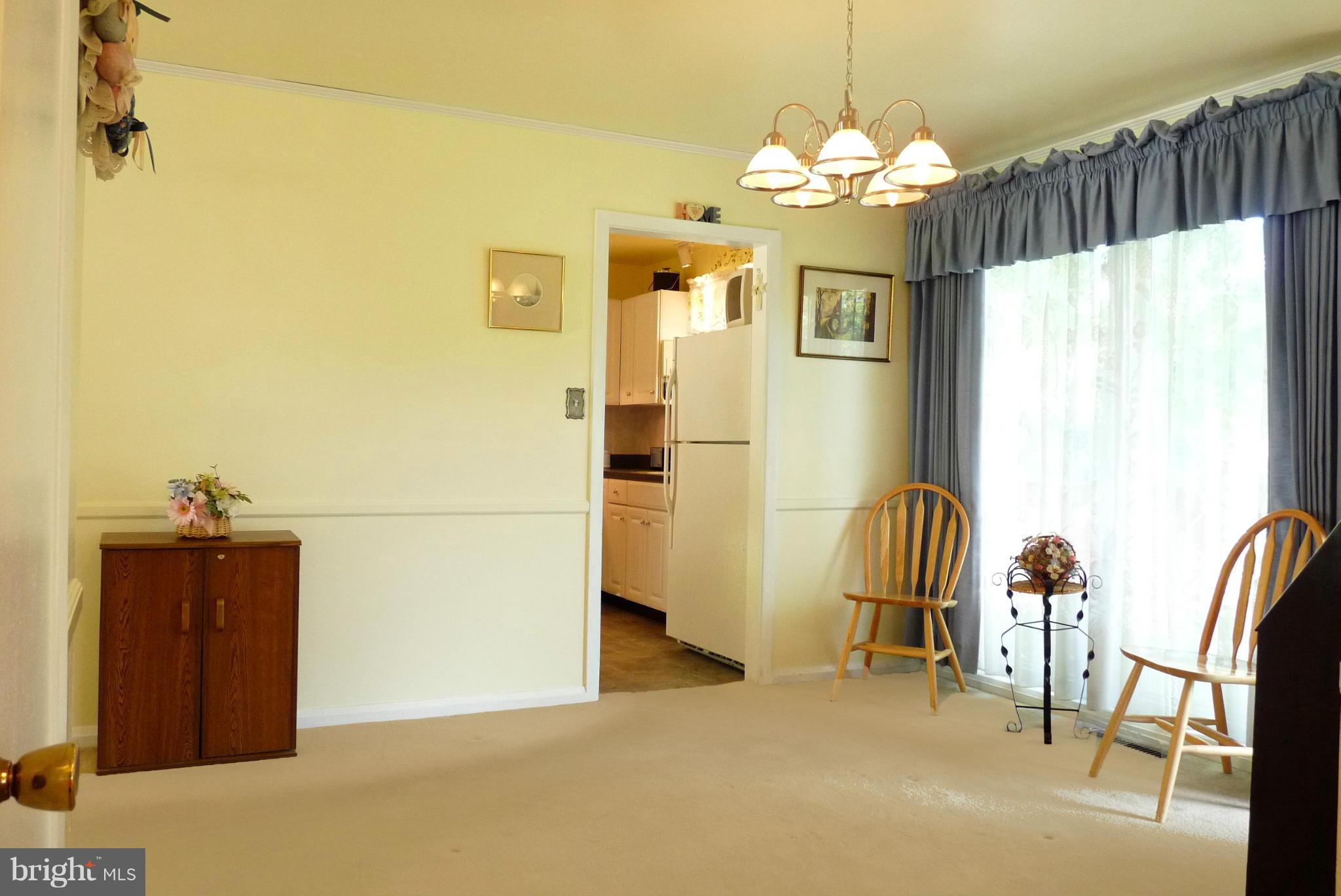 1812 Willann Road Baltimore, MD 21237 - Photo 5 of 26 a view of a dining room with furniture and chandelier