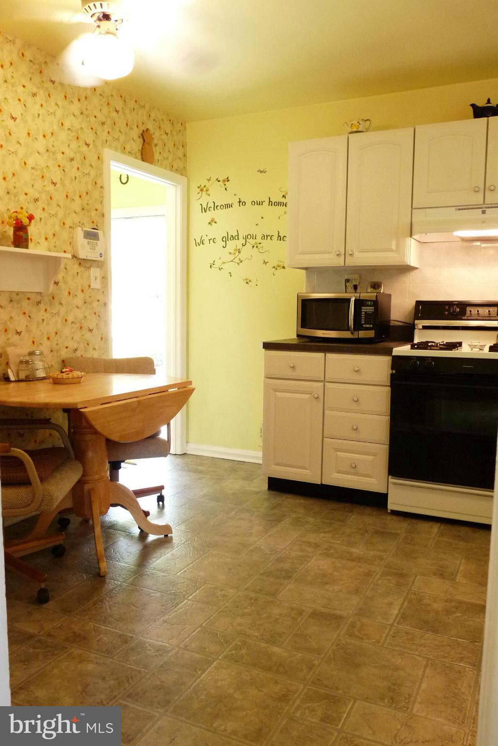 1812 Willann Road Baltimore, MD 21237 - Photo 8 of 26 a living room with a stove and a table
