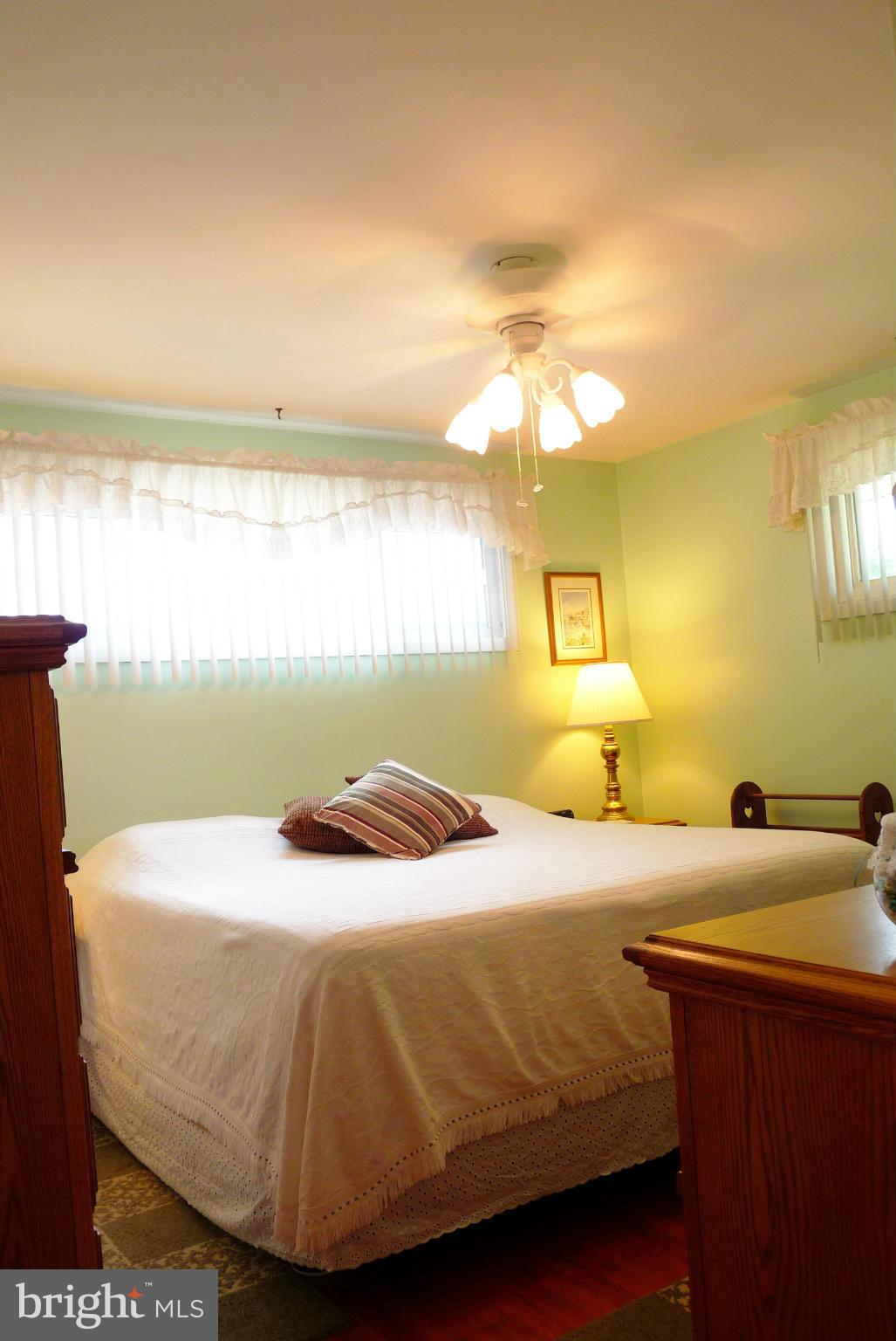 1812 Willann Road Baltimore, MD 21237 - Photo 9 of 26 a bedroom with a bed and a night stand