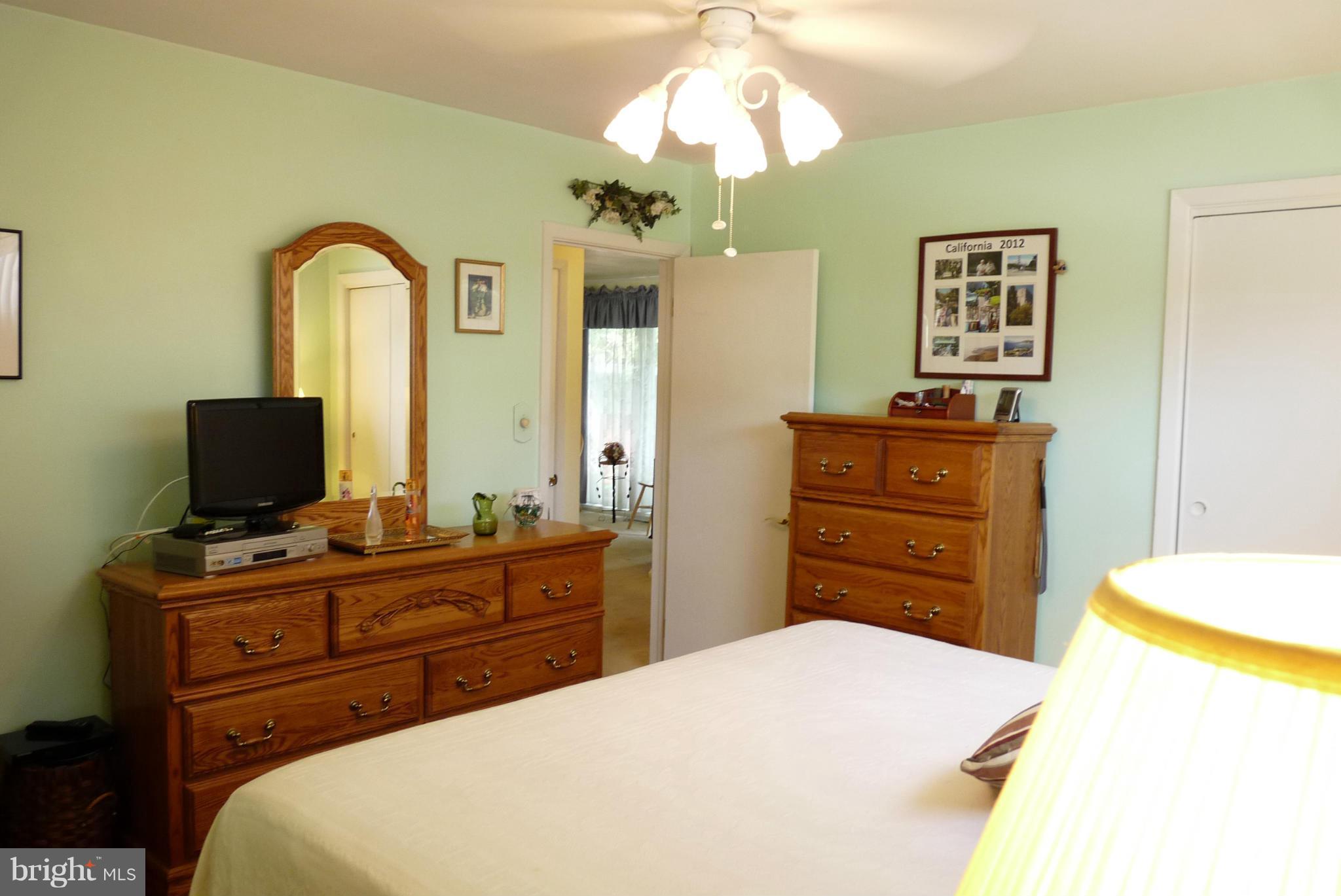 1812 Willann Road Baltimore, MD 21237 - Photo 10 of 26 a bedroom with a bed and a flat screen tv