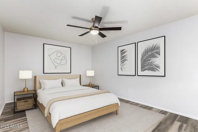 a bedroom with a bed and a painting on the wall