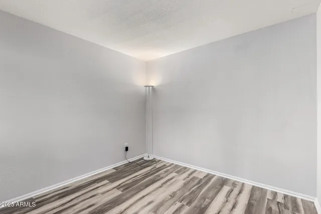 a view of a room with wooden floor