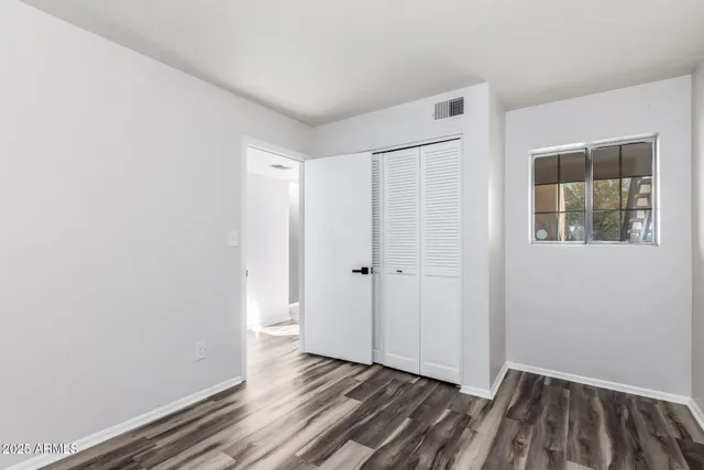 a view of a room with wooden floor and a window