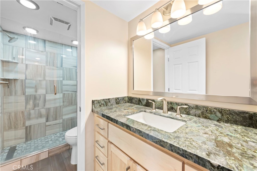 34110 Selva Road, Unit 323 Dana Point, CA 92629 - Photo 6 of 21 a bathroom with a granite countertop sink and a mirror