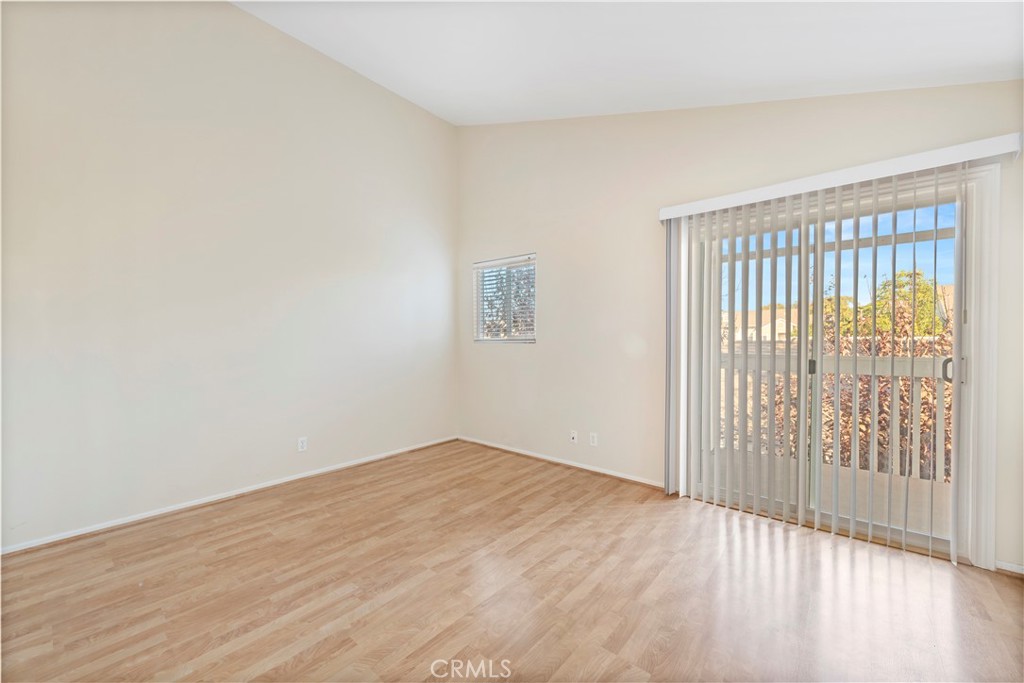 34110 Selva Road, Unit 323 Dana Point, CA 92629 - Photo 7 of 21 a view of an empty room with wooden floor and a window