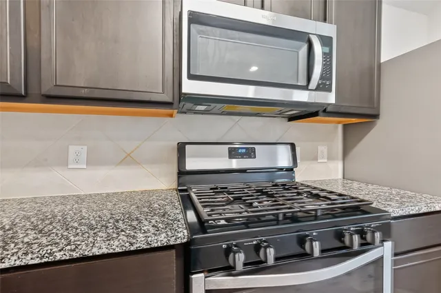 a stove top oven sitting inside of a kitchen